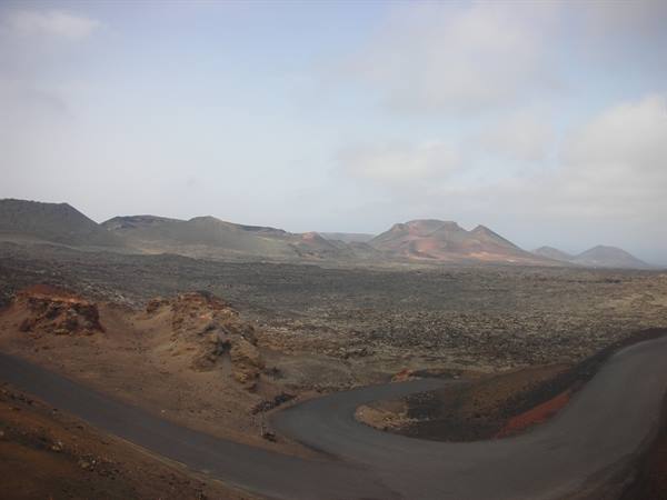 view of Timanfaya park: lava flows and the road