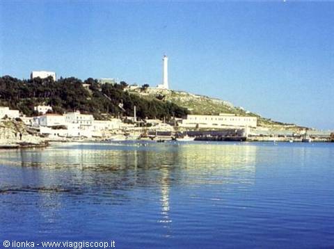 Santa Maria di Leuca lighthouse above the harbor, calm blue sea