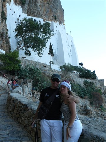 Tourist couple in front of the white Hozoviotissa monastery, Amorgos
