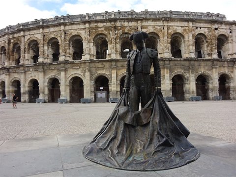 Bronze bullfighter statue in front of the Arles amphitheater
