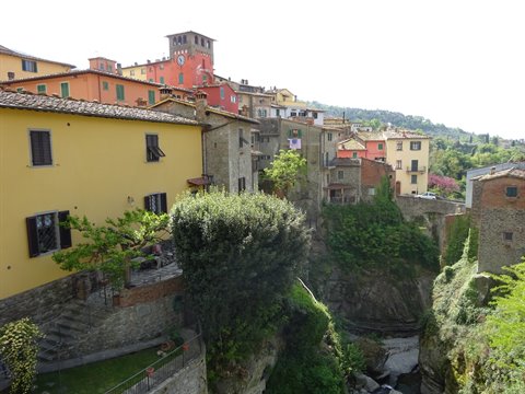 Colorful houses perched over rocky gorge in Loro Ciuffenna, Tuscany