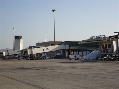 Fuerteventura airport: jet bridge P25 and control tower under clear sky
