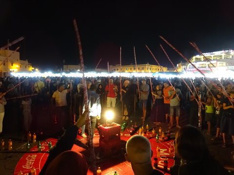 Night crowd with glowing sticks around an illuminated Coca-Cola stage