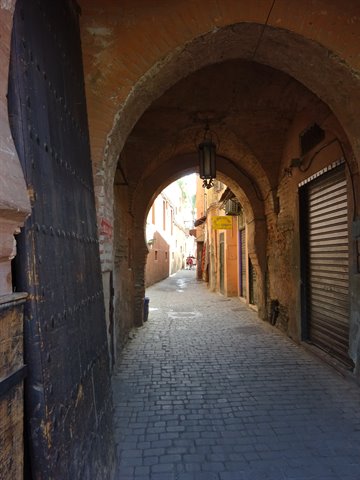 Brick arch over a cobbled alley in the Marrakech medina