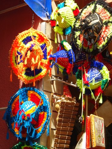 Colorful embroidered hats hanging at a Marrakech shop
