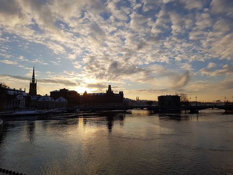 Gamla Stan in Stockholm: spires and buildings reflected in the icy water at morning
