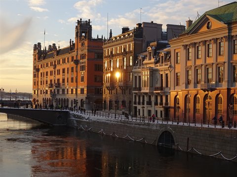 Stockholm, historic buildings lit by low sun along the snowy waterfront