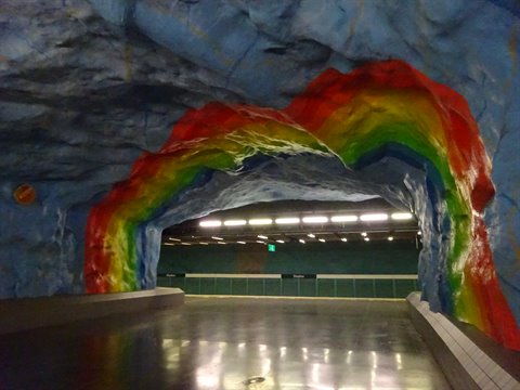 Stadion metro station, painted rock rainbow over blue cave ceiling