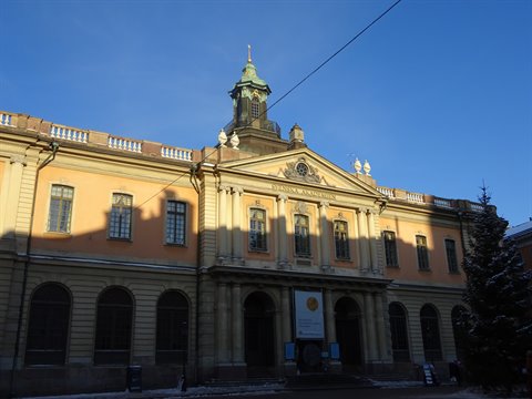 Nobel Museum in Stockholm, ochre facade lit by winter sun