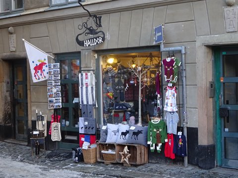 Souvenir shop Hallpot in Stockholm old town with sweaters, plush toys and crafts outside