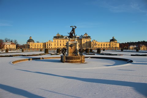 Bronze fountain statue in snowy garden before Drottningholm Palace, Stockholm