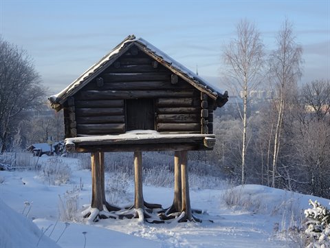 Log storehouse on stilts covered in snow at Skansen, Stockholm