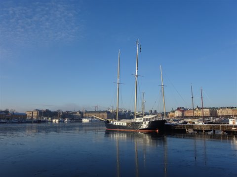 Three-masted tall ship moored in Stockholm's icy harbor