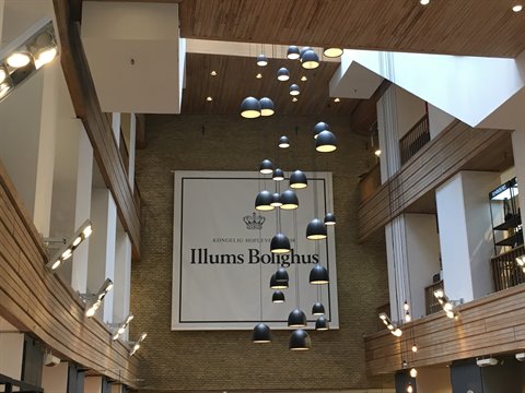 Black pendant lamps at Illums Bolighus atrium with wood and brick