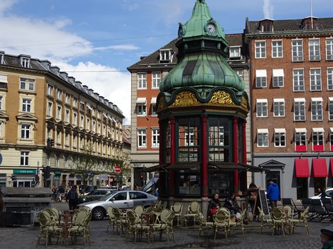 Green copper kiosk at Kongens Nytorv, Copenhagen, with café chairs around