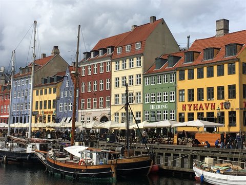 Sailboats moored in front of Nyhavn's colorful townhouses in Copenhagen