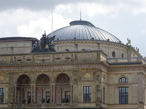 Royal Danish Theatre in Copenhagen, copper dome and bronze statues against cloudy sky
