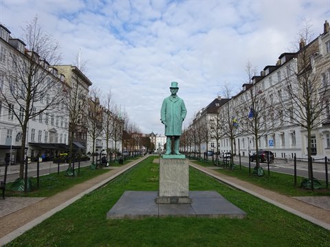 Bronze statue of Hans Christian Andersen on a stone base in Copenhagen
