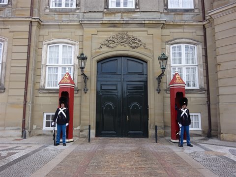 Danish royal guards standing in red sentry boxes at Amalienborg Palace entrance