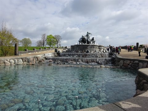 Visitors admire the Gefion Fountain with bronze statues and stone water basin
