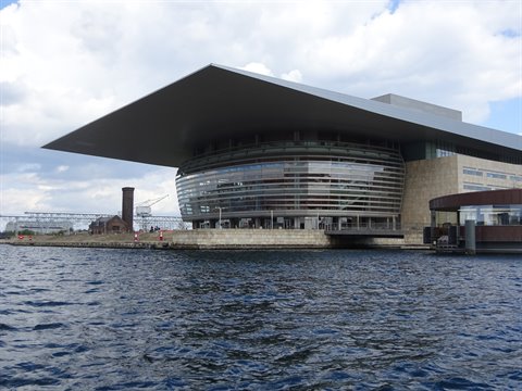 Copenhagen Opera House with overhanging roof above the harbour water