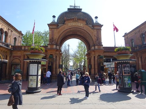 Visitors in front of the brick arch entrance of Tivoli in Copenhagen