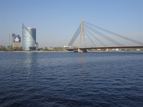 Riga's cable-stayed bridge over the Daugava river, glass towers under clear sky