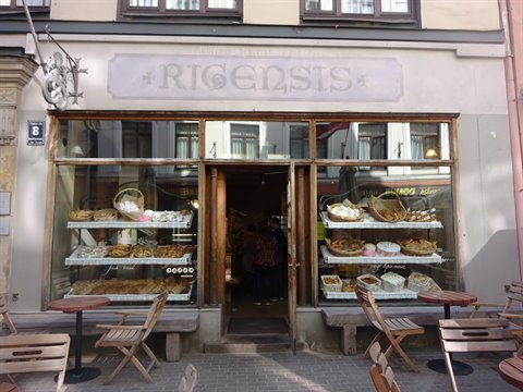 Rigensis bakery in Riga, windows with bread and wooden sidewalk tables