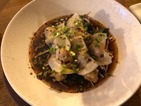 Steamed dumplings with scallions and soybean sprouts in soy sauce