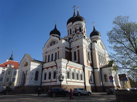 Alexander Nevsky Orthodox Cathedral in Tallinn, black domes and crosses under blue sky