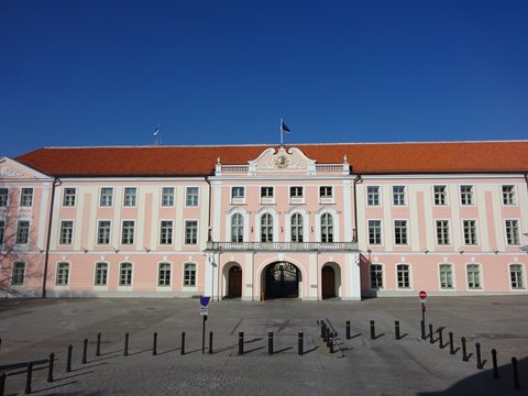 Pink Riigikogu parliament building on Toompea hill, Tallinn, under blue sky