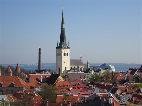 Tallinn: St Olaf's church spire rising over red rooftops toward the sea
