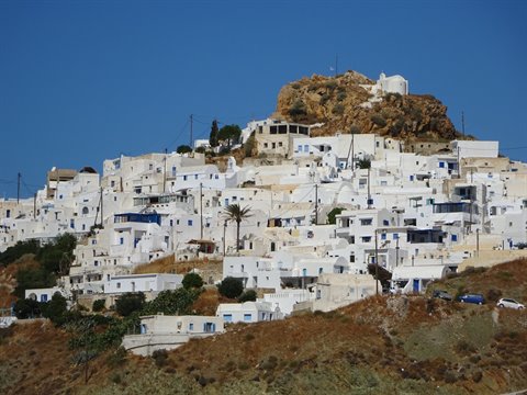 Whitewashed cubic houses clustered on a rocky hill, Ios