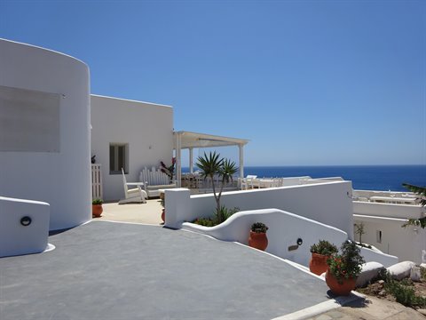 Whitewashed terraces with terracotta pots overlooking the Aegean Sea, Santorini