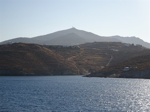 dry hills above blue Aegean sea in Kythnos, white houses among terraces