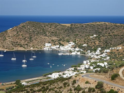 Sailing yachts anchored off a whitewashed Cycladic village in Sifnos
