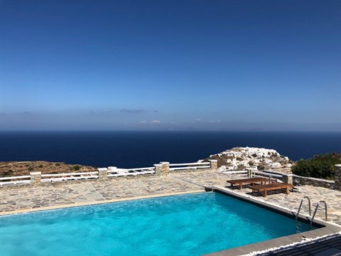 Infinity pool with white stone terrace over the Aegean Sea, Sifnos