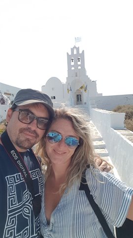 Selfie in front of the white bell tower church in Sifnos
