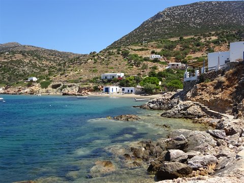 White houses over emerald bay among rocks and hills in Sifnos