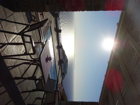 Terrace with table, chairs and pool overlooking the Aegean Sea in Sifnos