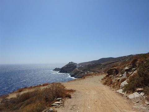 Dirt road through dry shrubs toward Kastro coastline, Sifnos
