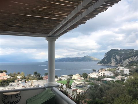 Wooden pergola terrace with white column overlooking the sea in Capri