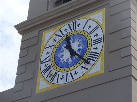 Blue majolica clock with Roman numerals on Capri's bell tower