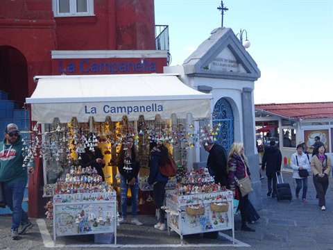 Tourists browse souvenirs at La Campanella stall in Capri