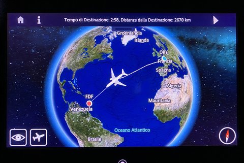 In-flight screen showing route map to Fort-de-France, plane over the Atlantic