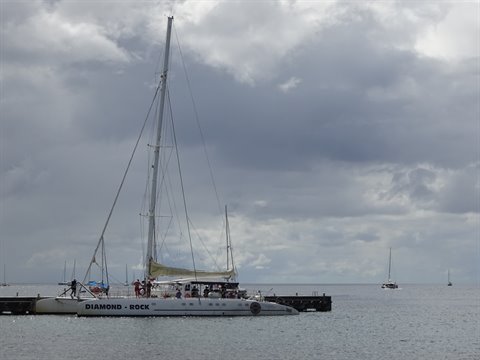 Diamond Rock catamaran moored at the pontoon under cloudy skies