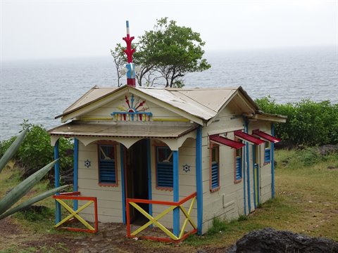 Blue painted wooden hut facing the sea, Martinique