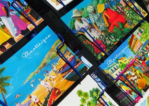 Painted Martinique postcards showing beaches, boats and women in traditional dress