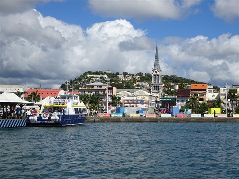 Ferry docked at Fort-de-France waterfront, Saint-Louis cathedral spire behind