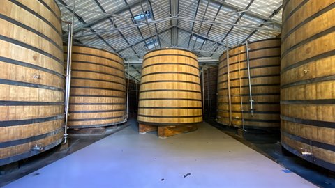 Huge oak vats inside the Saint-Étienne rum distillery aging hall